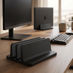 Pillar laptop dock on a minimalist desk beside a monitor and keyboard