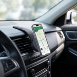 Gravity car mount in a modern car interior holding a phone showing navigation