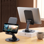 Pivot phone stand on a desk holding a phone playing video beside a laptop